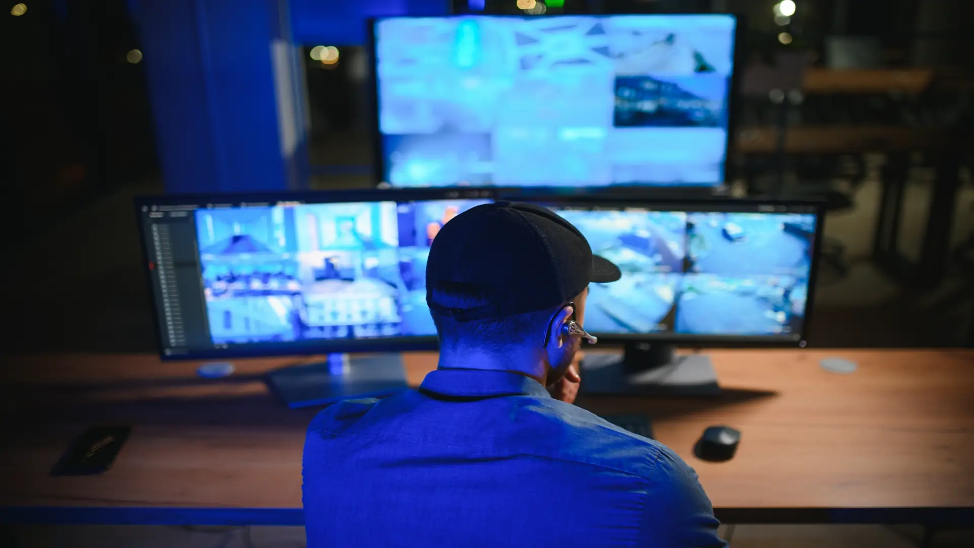Security operator controlling CCTV cameras in office