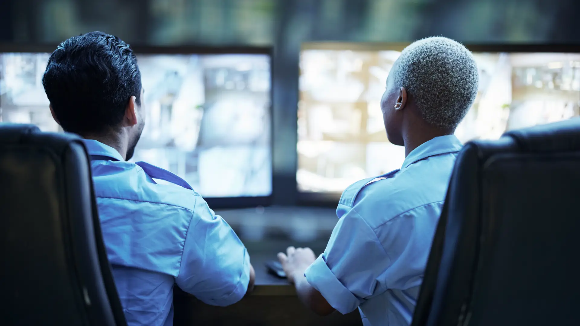 Security guard team checking screens in control room