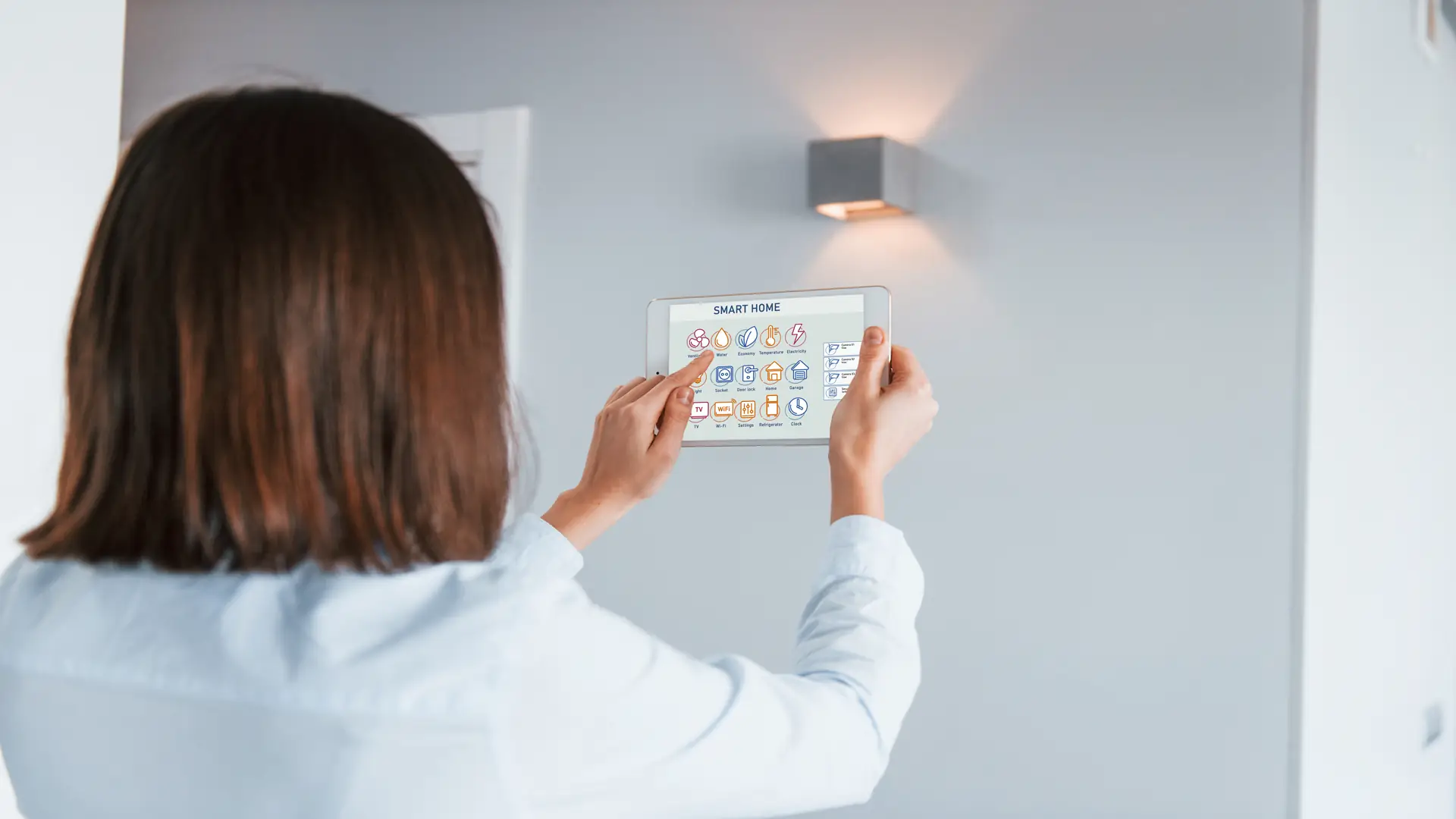 Rear view of woman controlling smart lighting