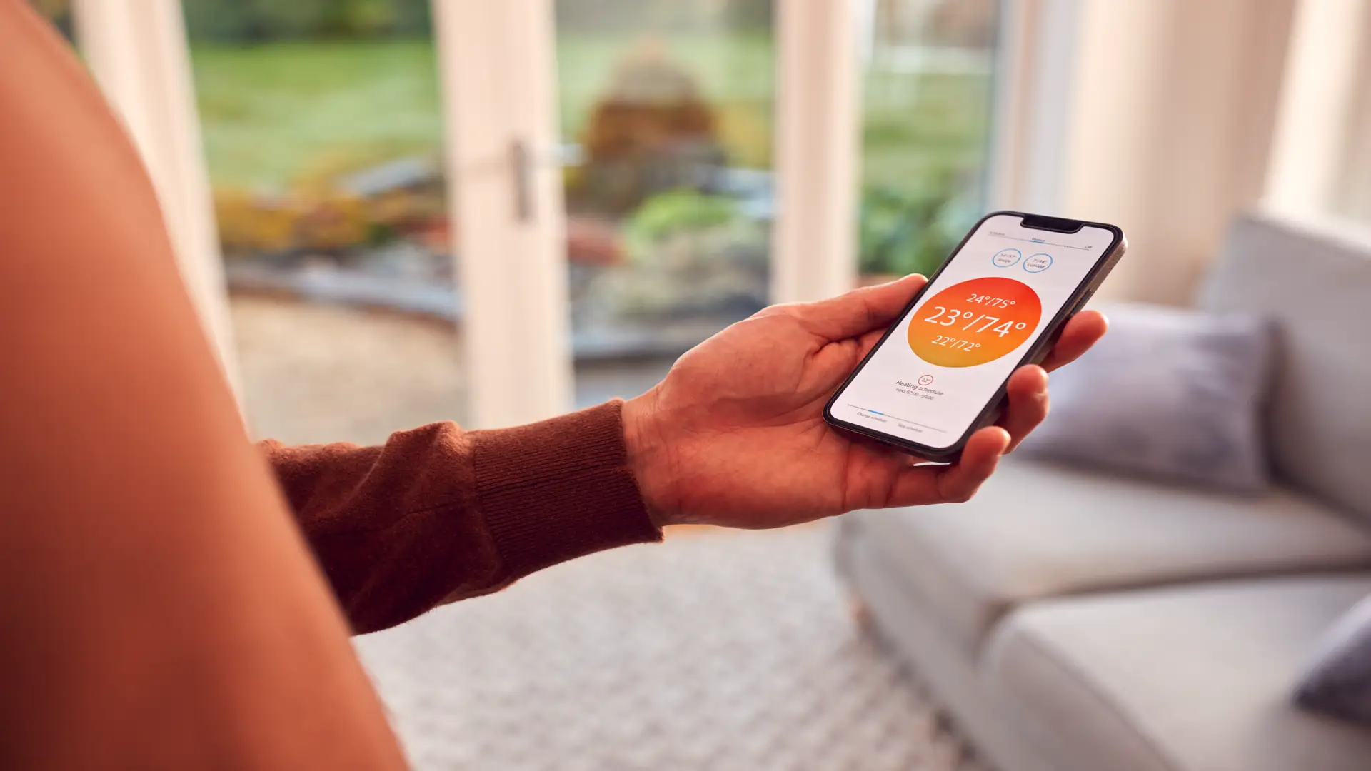Man at home looking at app on smartphone