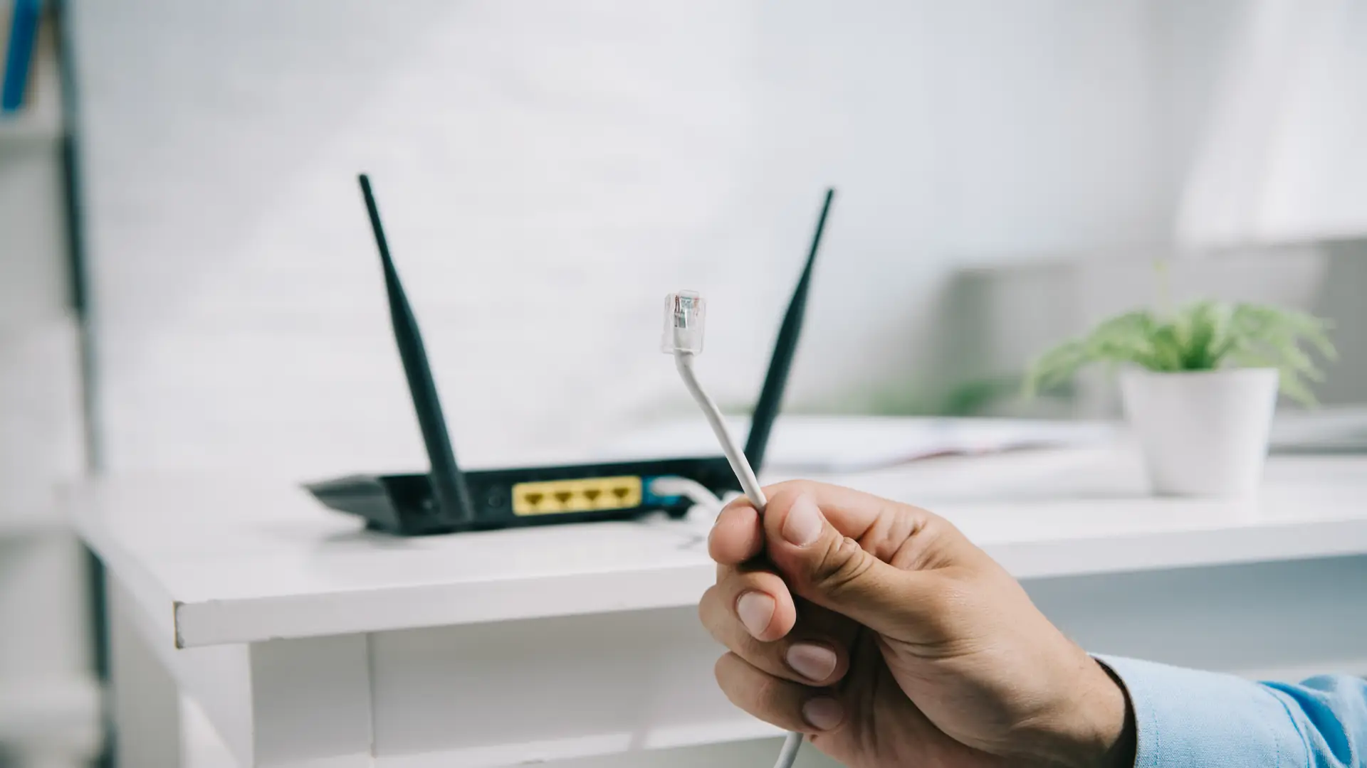 Businessman holding wire with connection