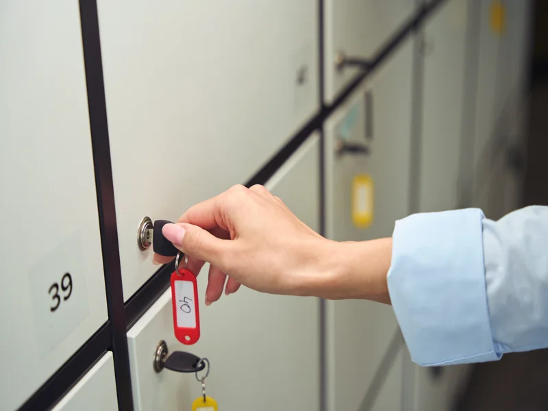 Adult person opening closed storage locker cabinet