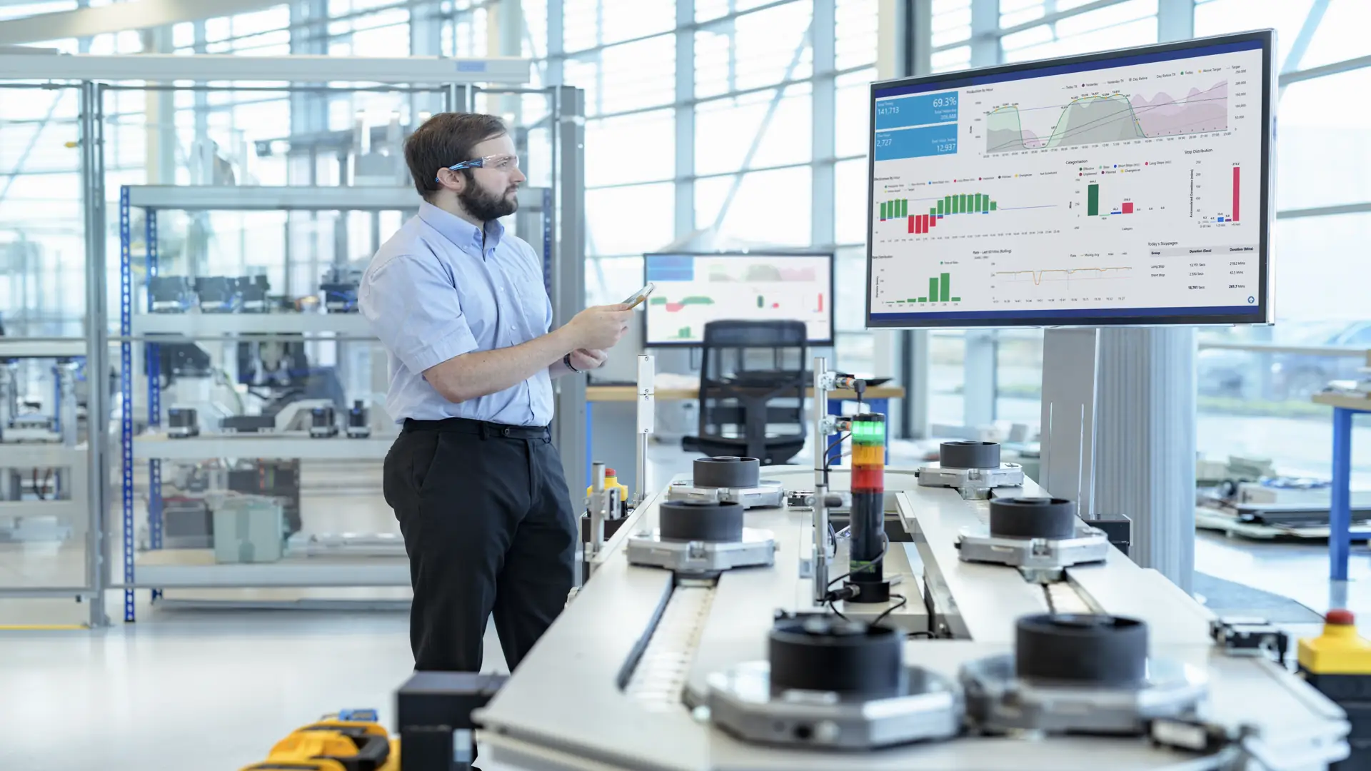 Engineer testing robotic production simulator