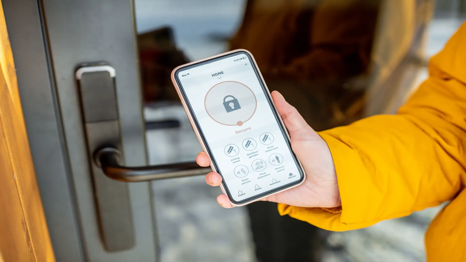 Person locking entrance door with smartphone
