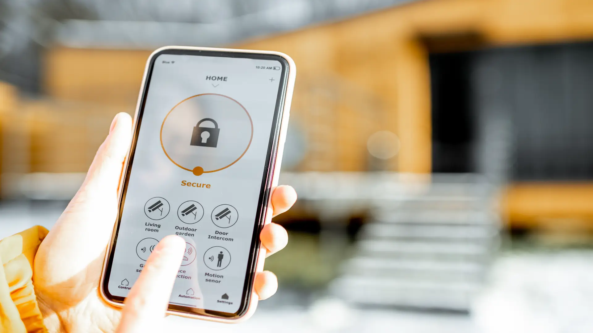 Person controlling home security from mobile device