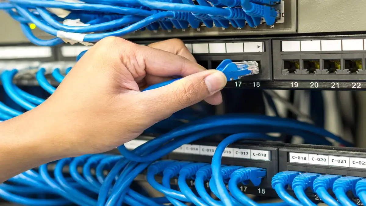 Hand plugging network cable connection